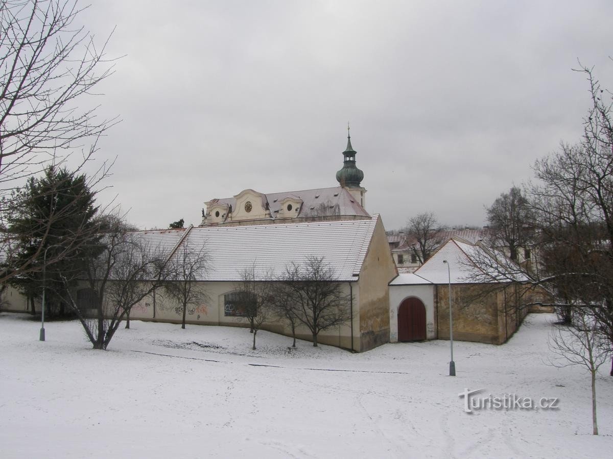 The basilica is almost lost behind the farm buildings