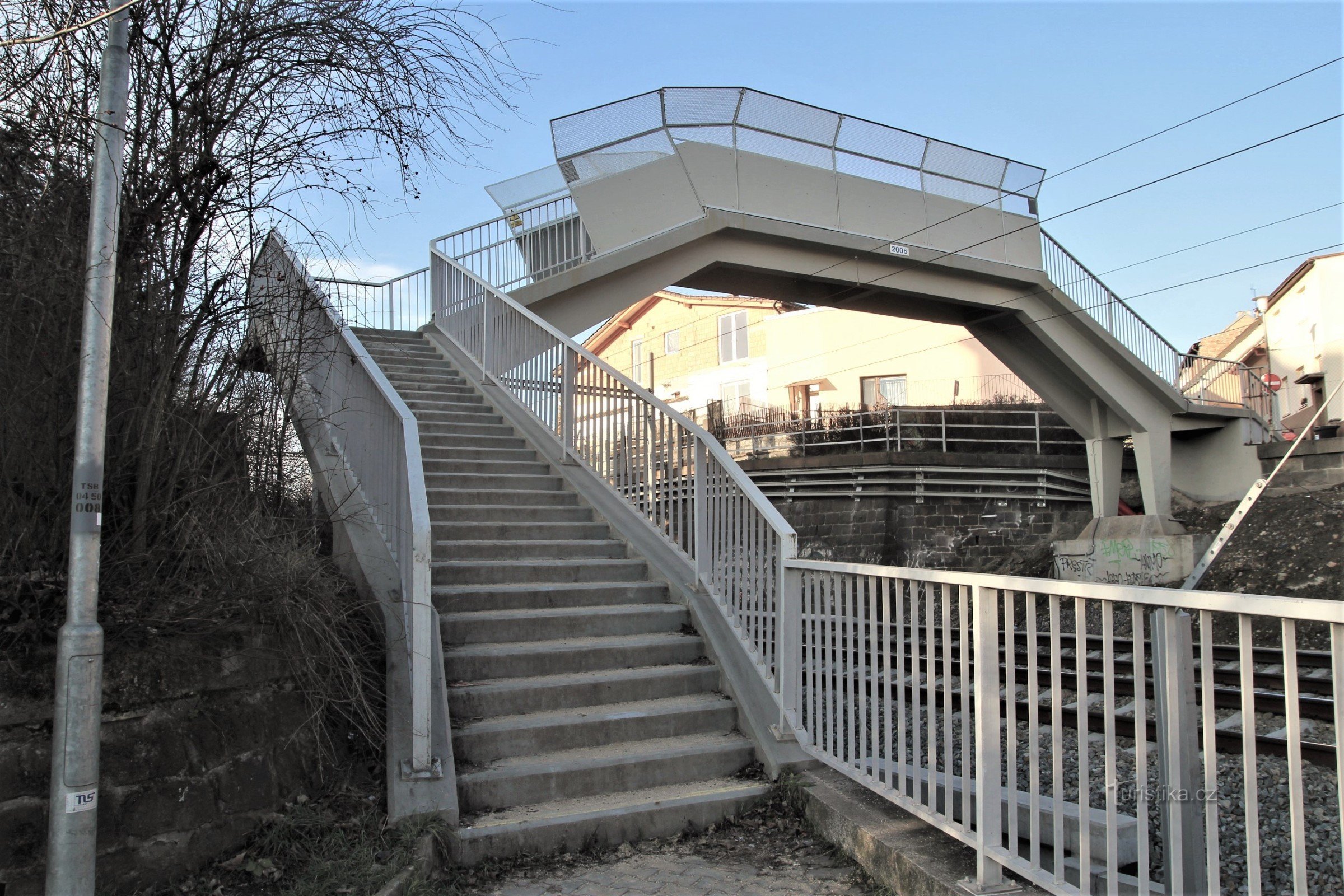 Brno-Obřany - pasarela sobre la vía férrea junto a la iglesia