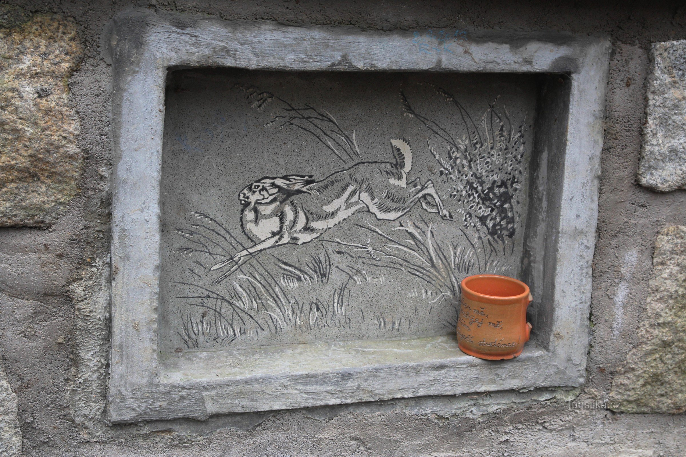 Detail of a well with a drawing of a hare