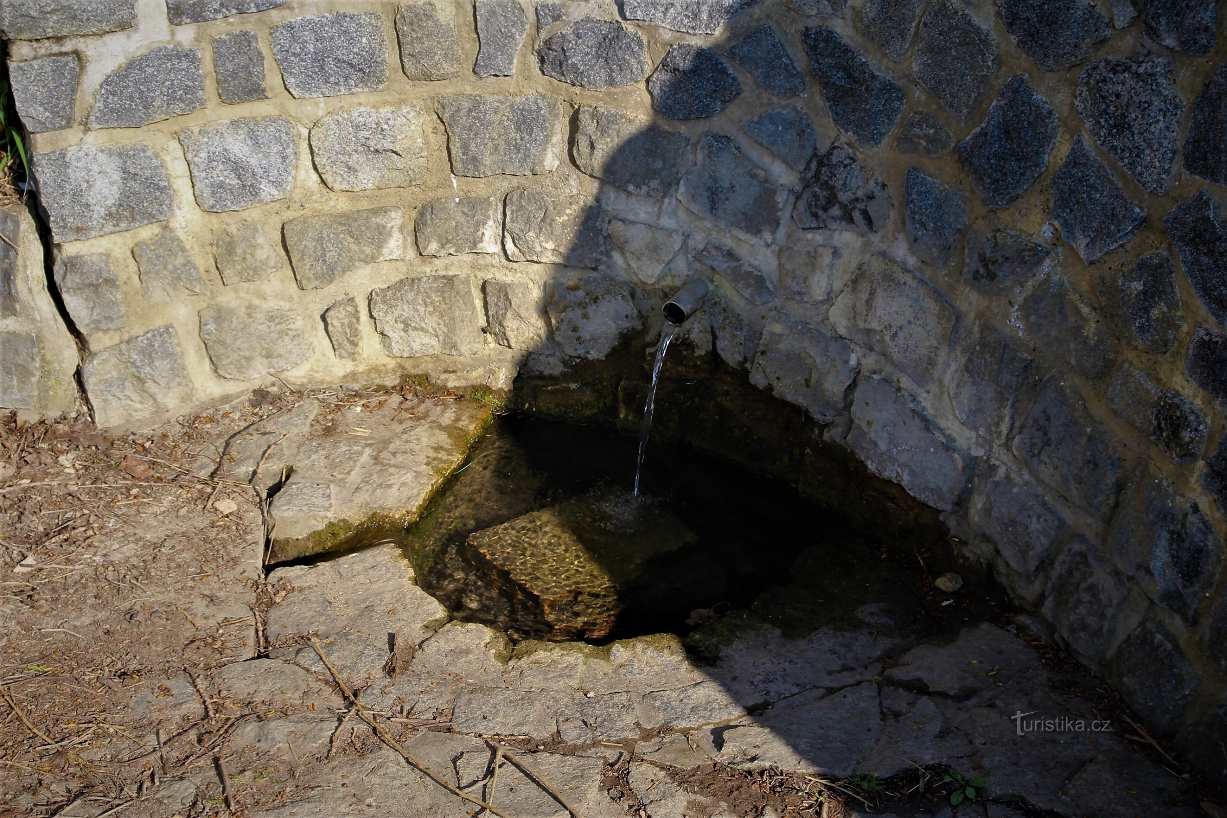 Detail of a well with a small pit