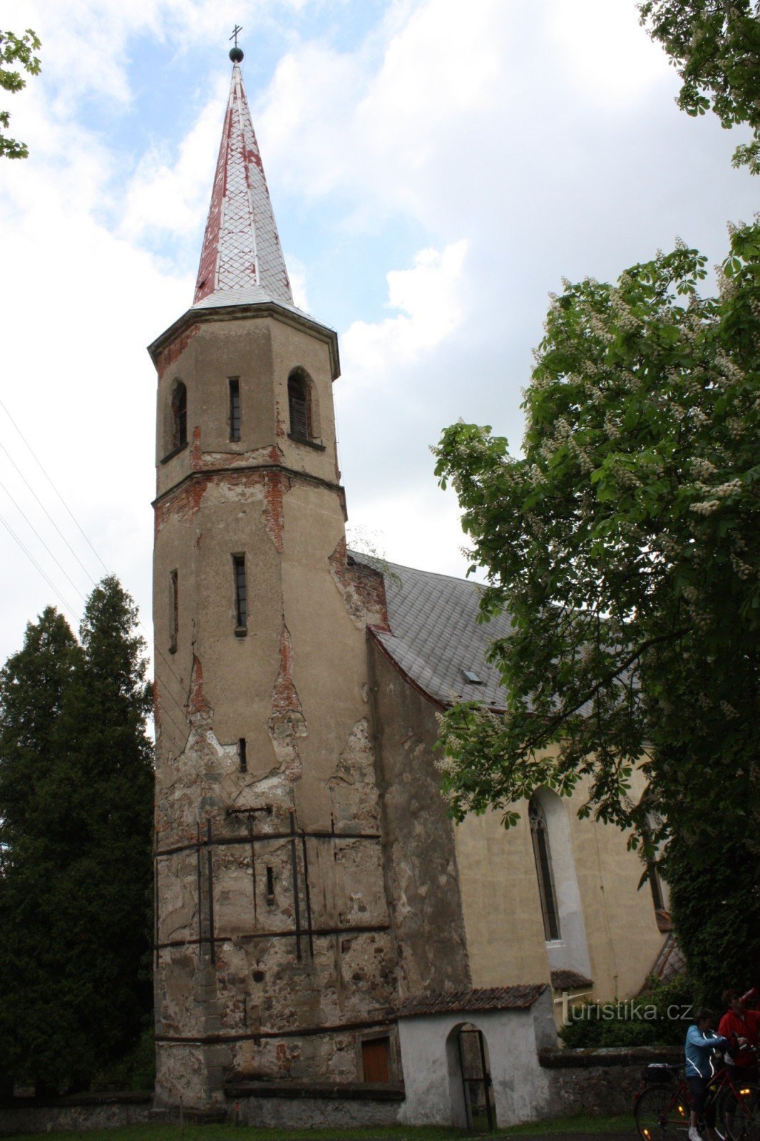 Two landmarks of the settlement of Práčov - the church and the water tower