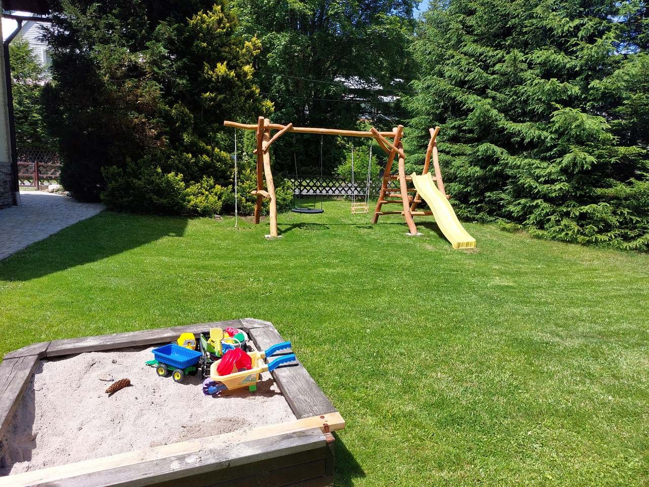 Swings, slide and sandpit for children