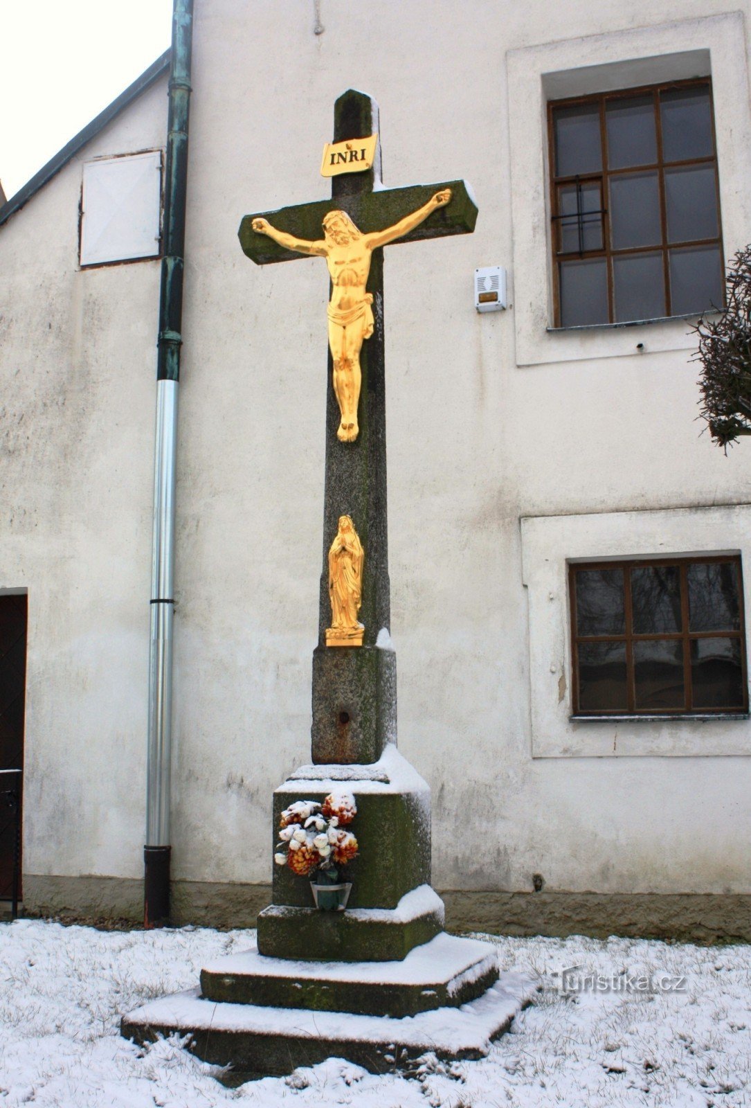 Stone cross in front of the chapel