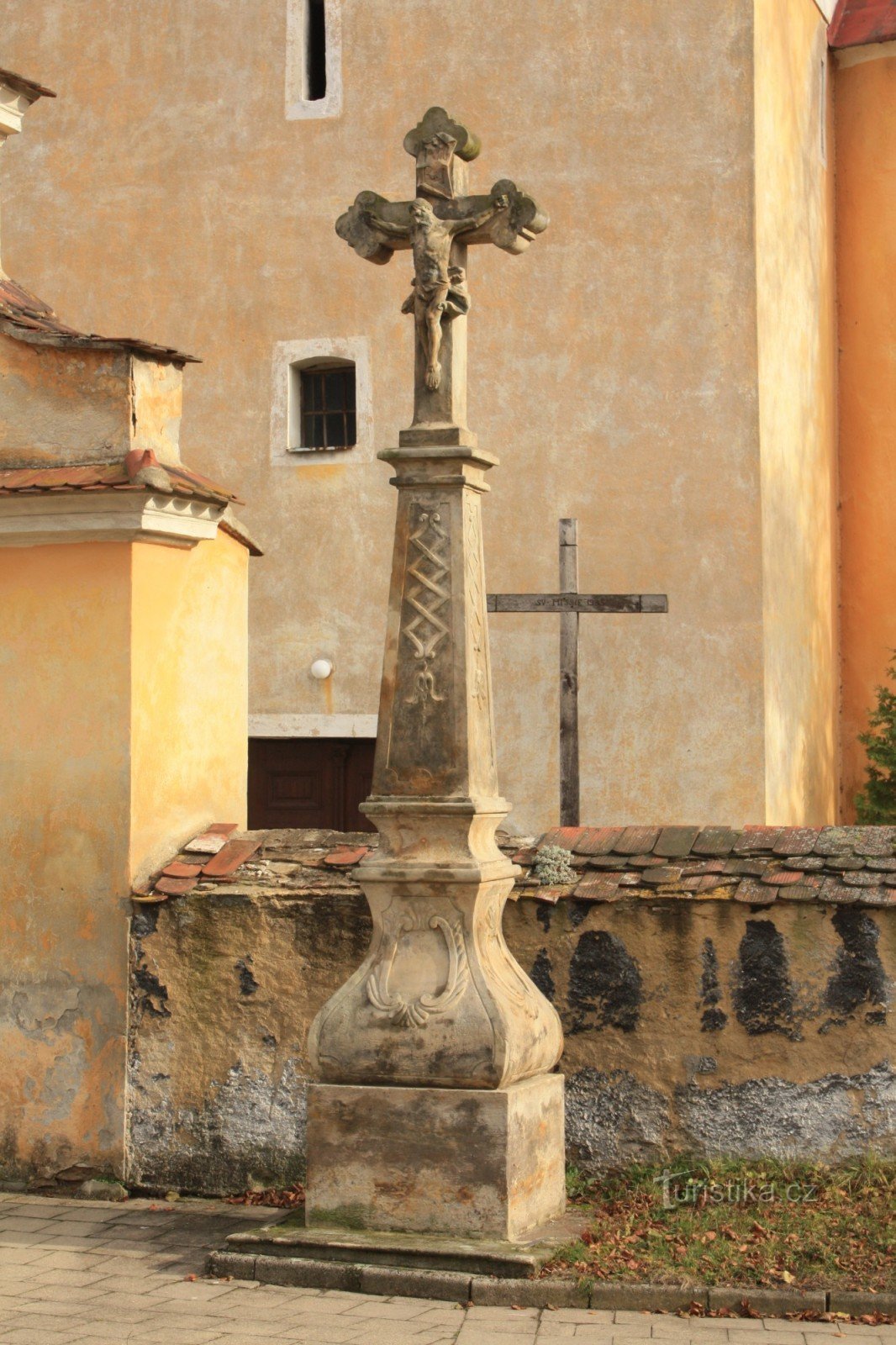 Stone cross in front of the church