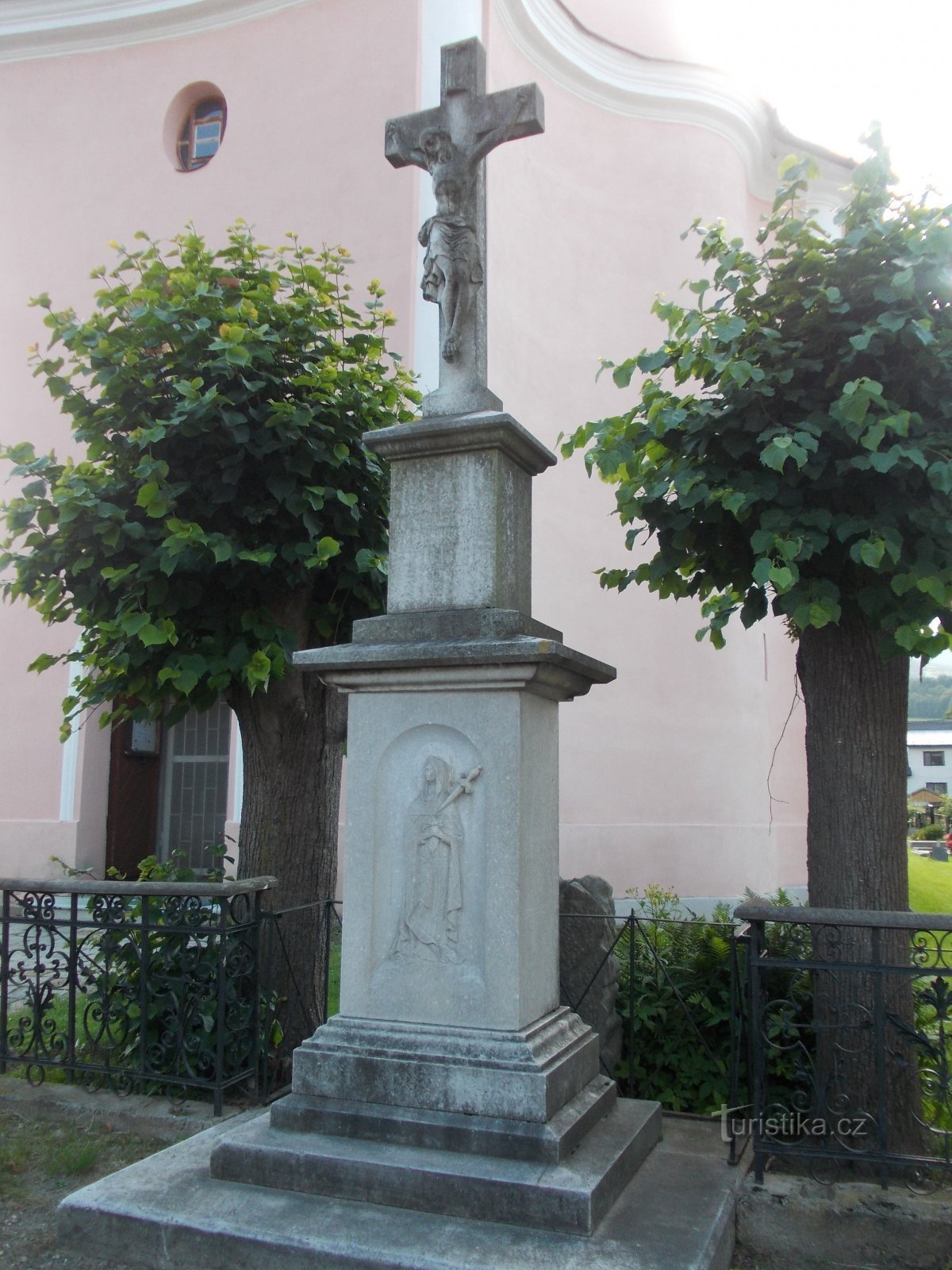 stone cross in front of the church