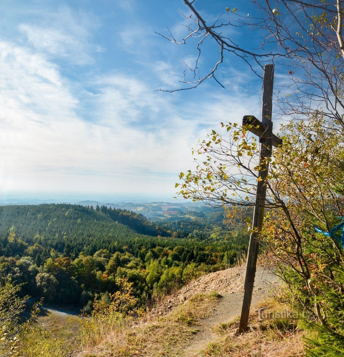 Cross on the edge of the quarry wall on the slope of Špičák (841 m above sea level)