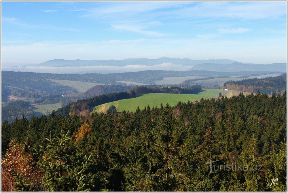 Krkonoše 山脉从低矮的云层中出现，右边是 Vraní 山脉的山顶和 Královecký Špičák