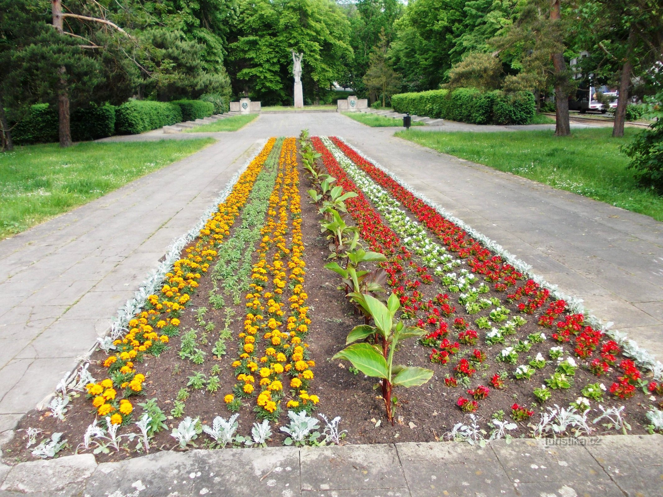 Blumenarrangement rund um das Denkmal