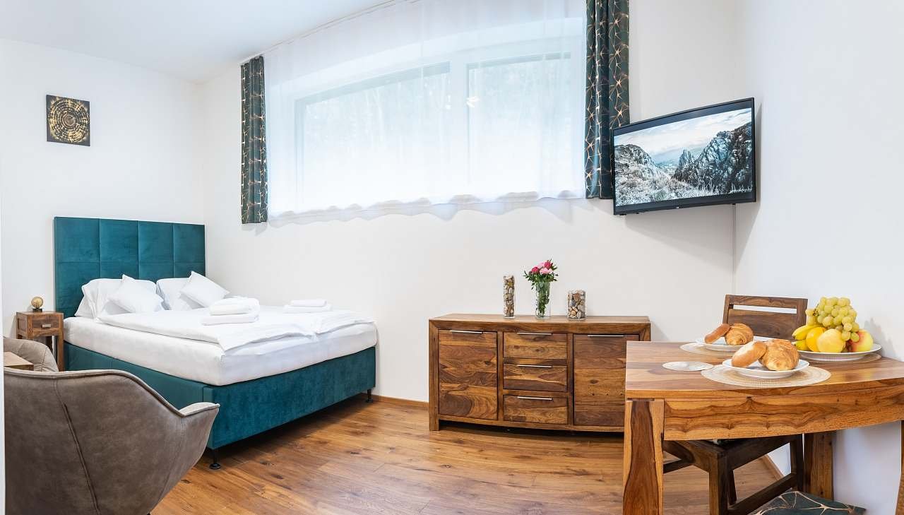 The luxury apartment KRKONOŠE is equipped with massive furniture made of exotic wood