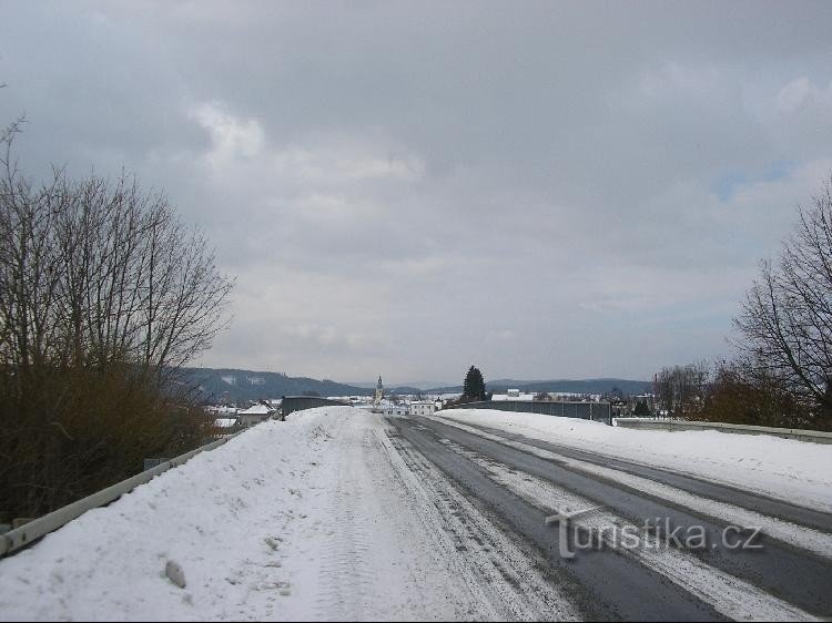 The blue sign leads along the road: and that road goes over the Mohelnice-Olomouc expressway