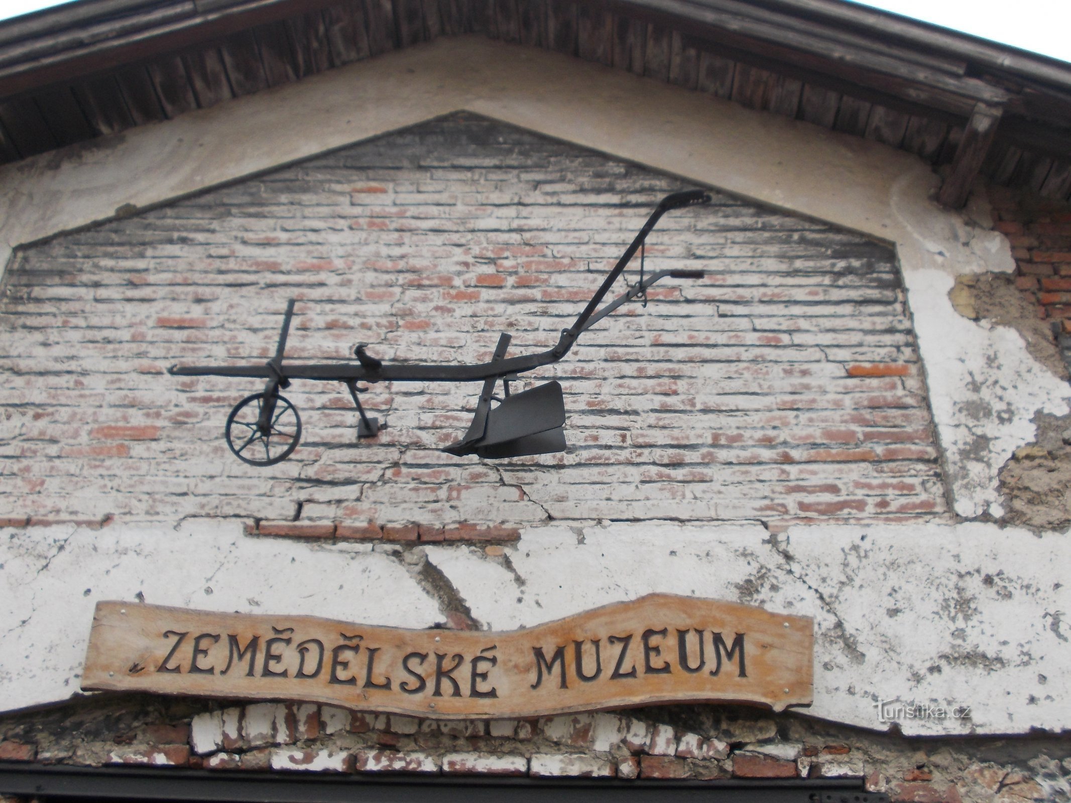 inscription and horse plow on orange