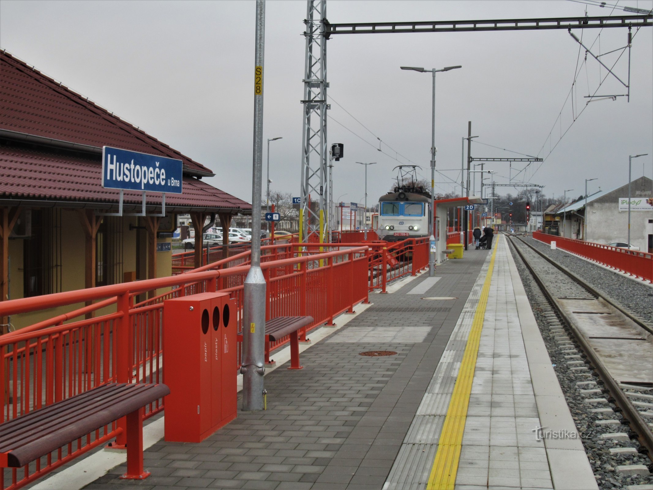Newly opened electrified station with train arrival in December 2020