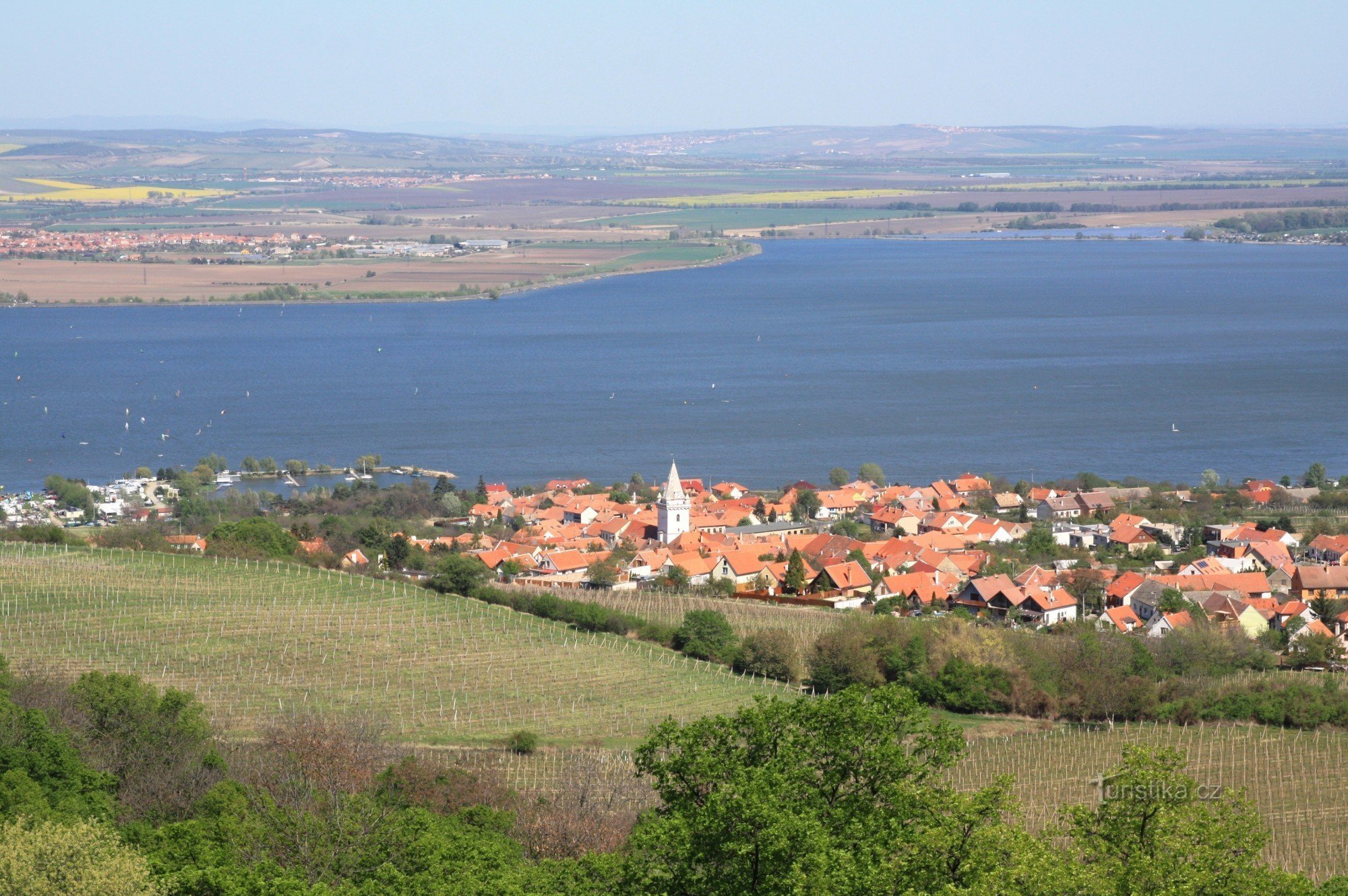 Novomlýn reservoir with the village of Pavlov and a campsite