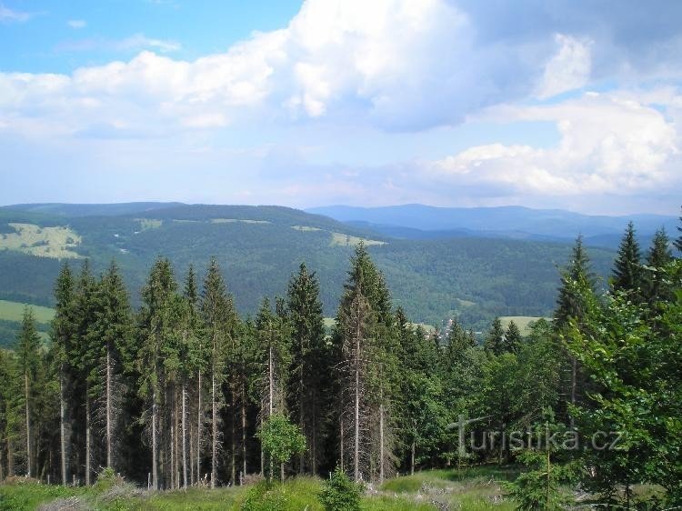 from the road: Kunčická hora in the Rychlebské hory on the left, then an individual hill on the right