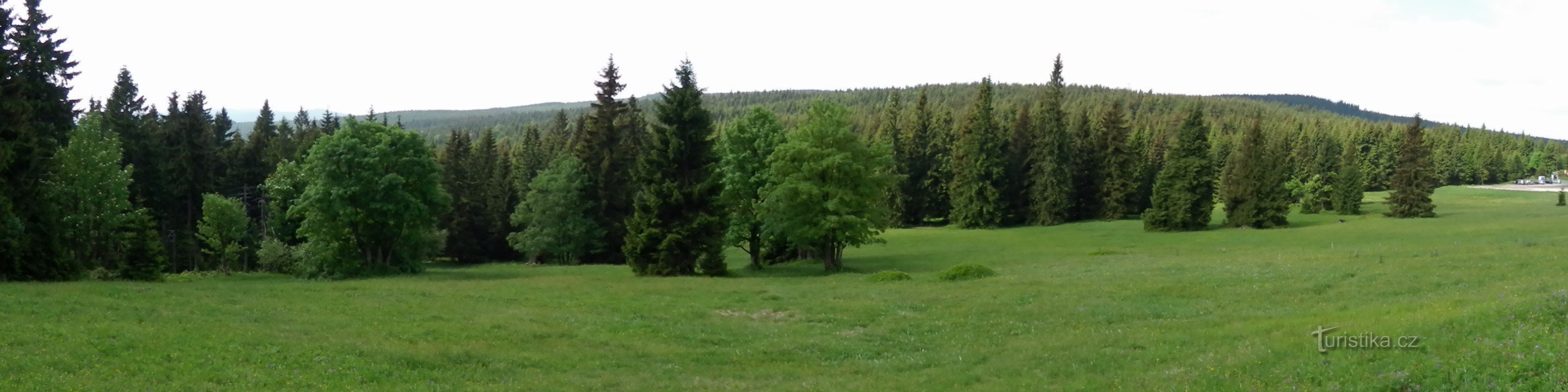 Panoramiczne ujęcie starej łąki, po prawej stronie parking Mořina