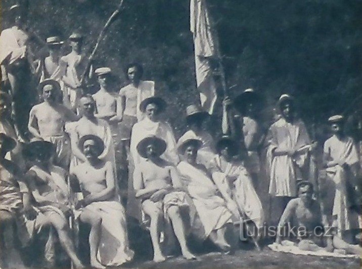 Men's group undergoing a procedure - historical photo from 1910