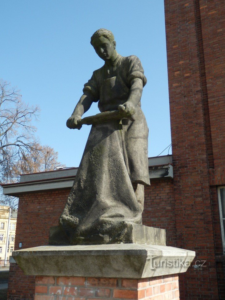 Sandstone statue of a tanner