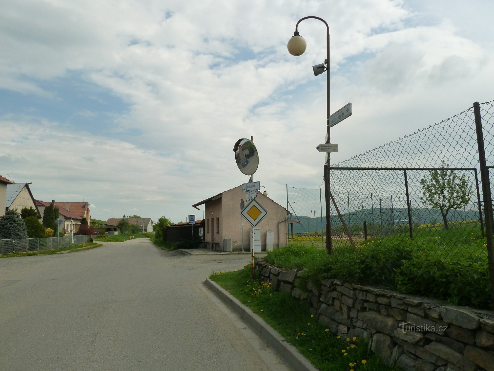 view of signpost and bus stop