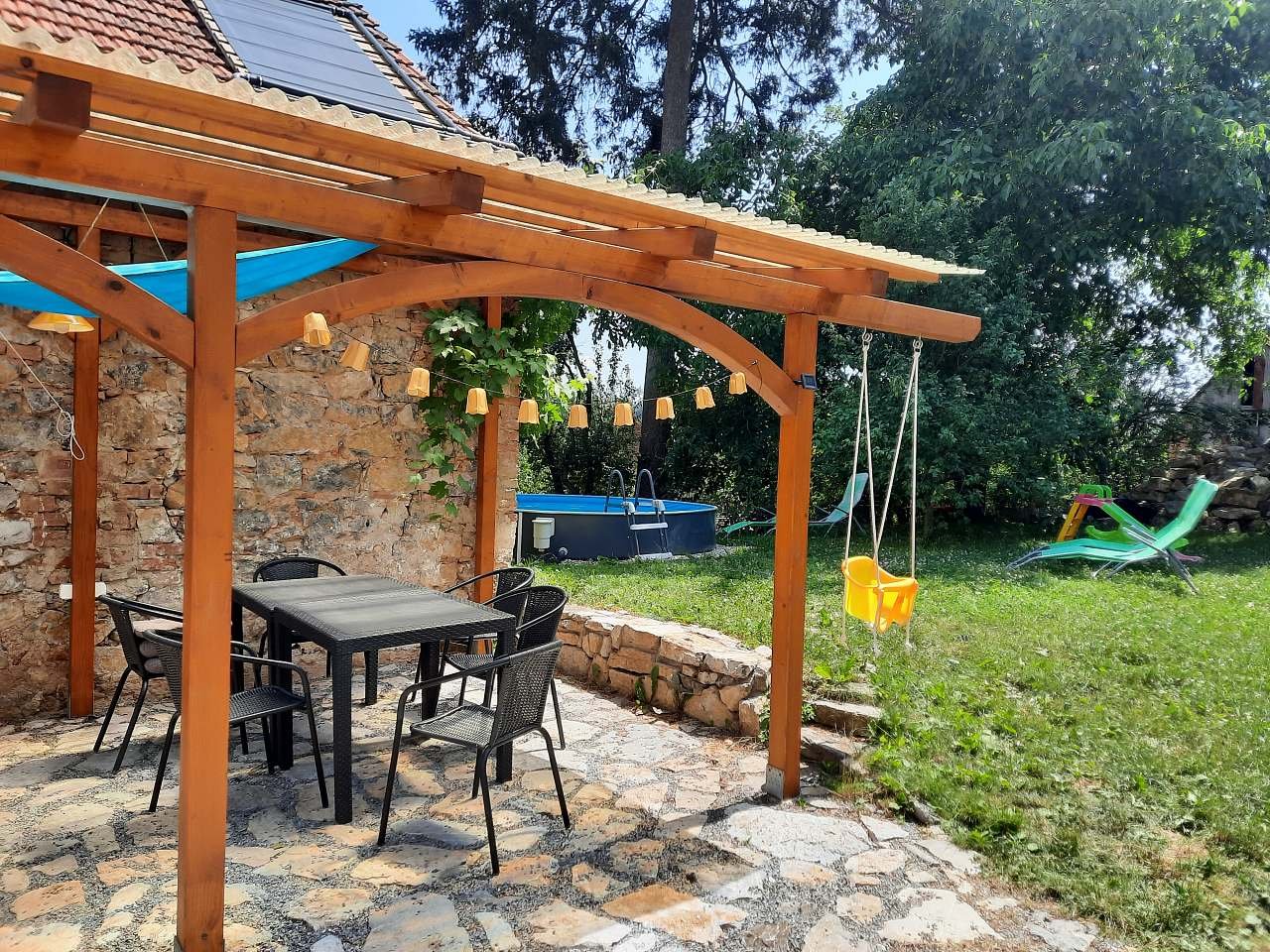 Seating under the pergola and pool