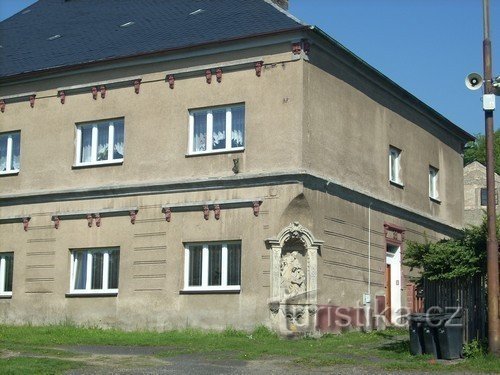 A corner house on the square with a sculpture...