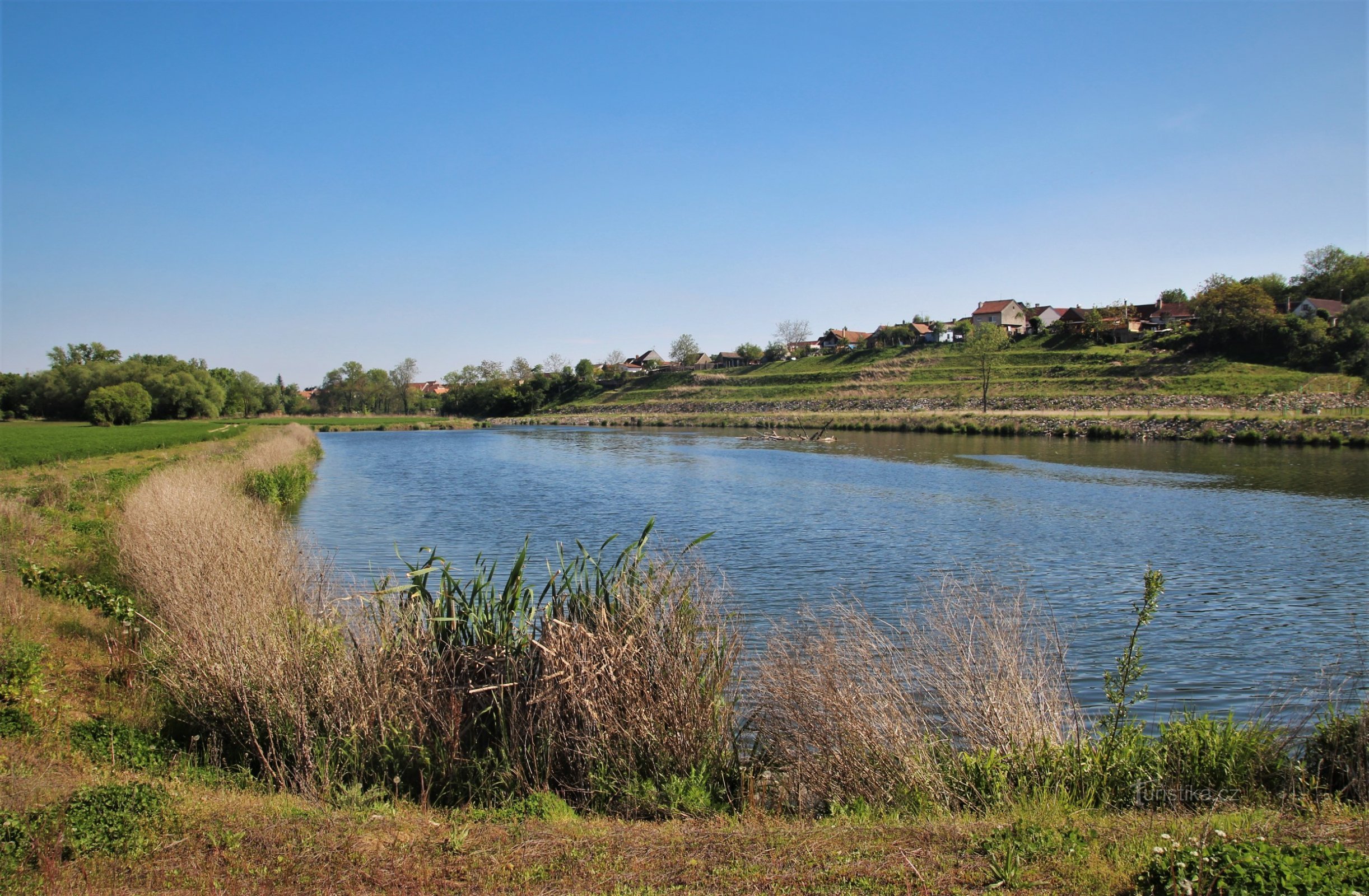 A vast pool of water and above it terraces of serious land