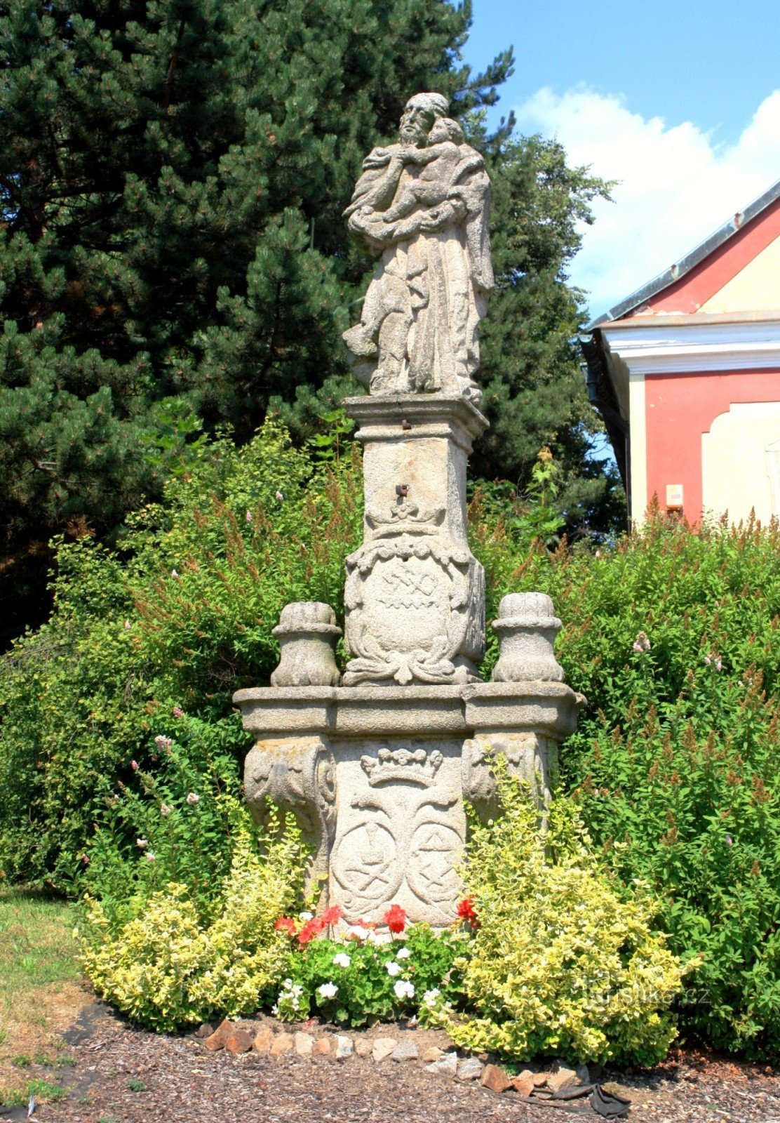 Staty av St. Josef med Jesusbarnet framför kyrkan