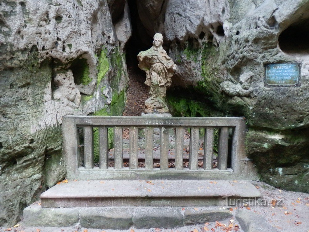 A statue of St. Procopius behind a stone railing