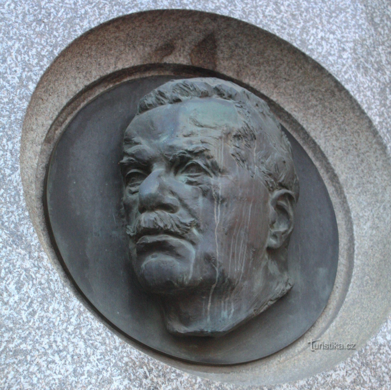 Sculptural portrait of Petr Bezruč on the building of the Railway Station