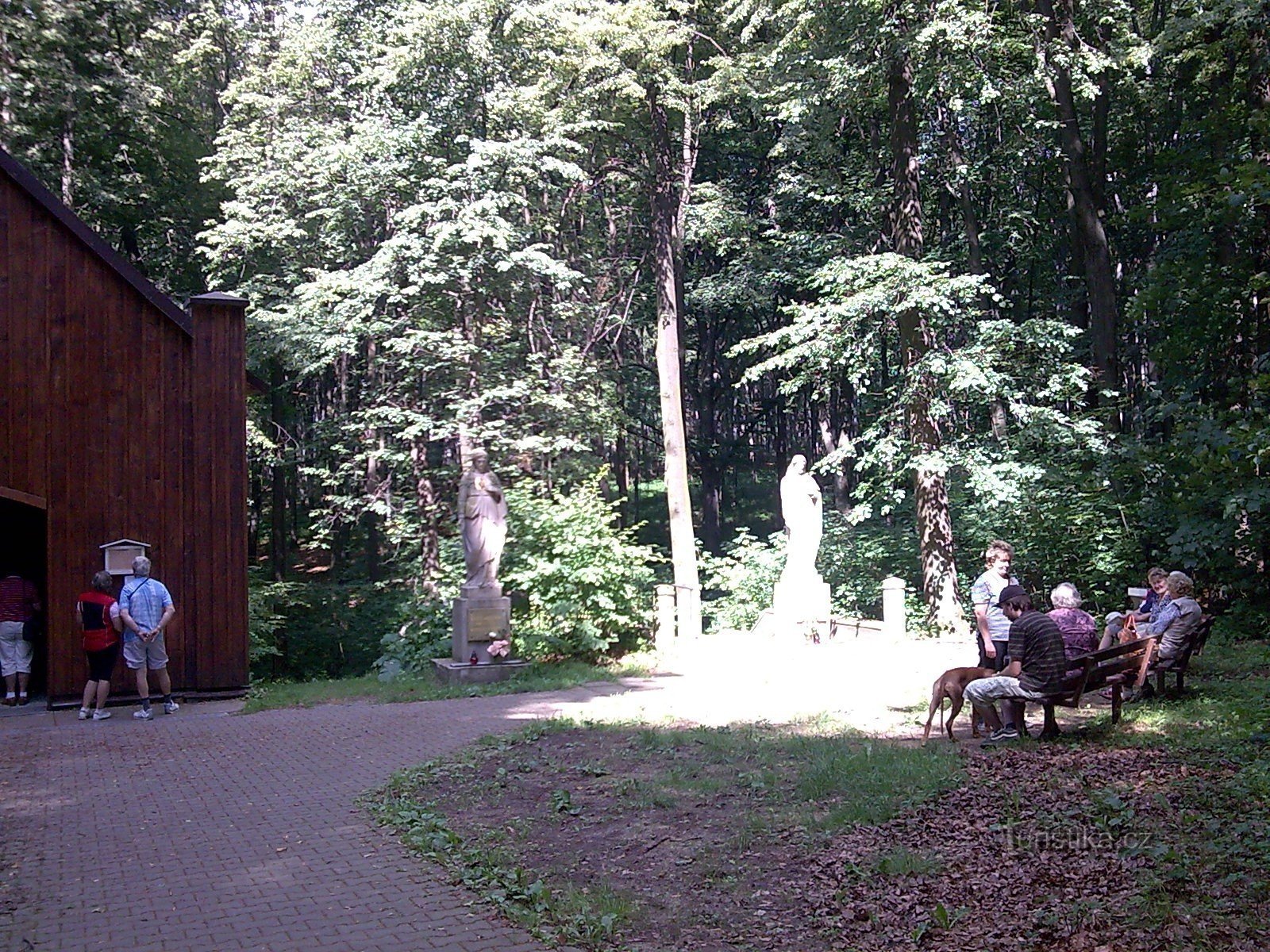 Statues by the chapel with seating.