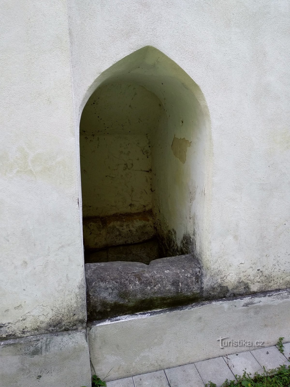 a well in the side of the chapel