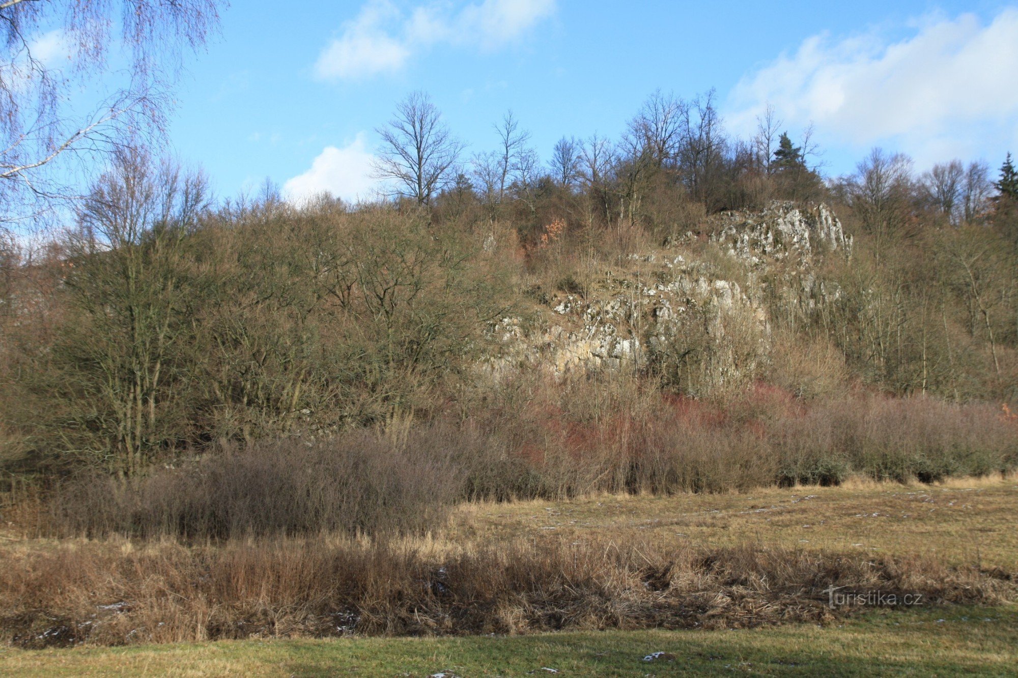 The entrance to the caves is located at the foot of a rocky slope