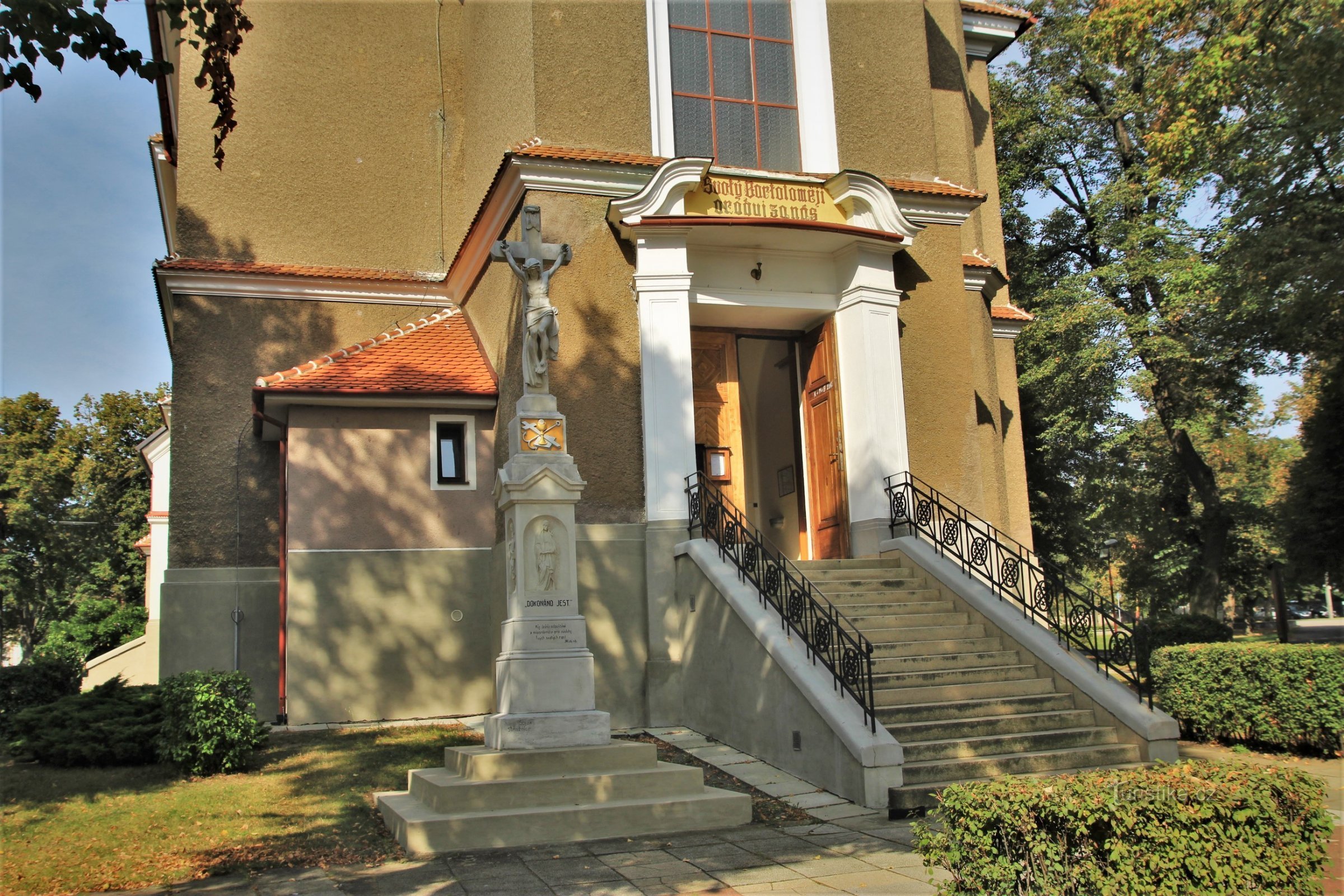 Entrance to the church with a stone cross