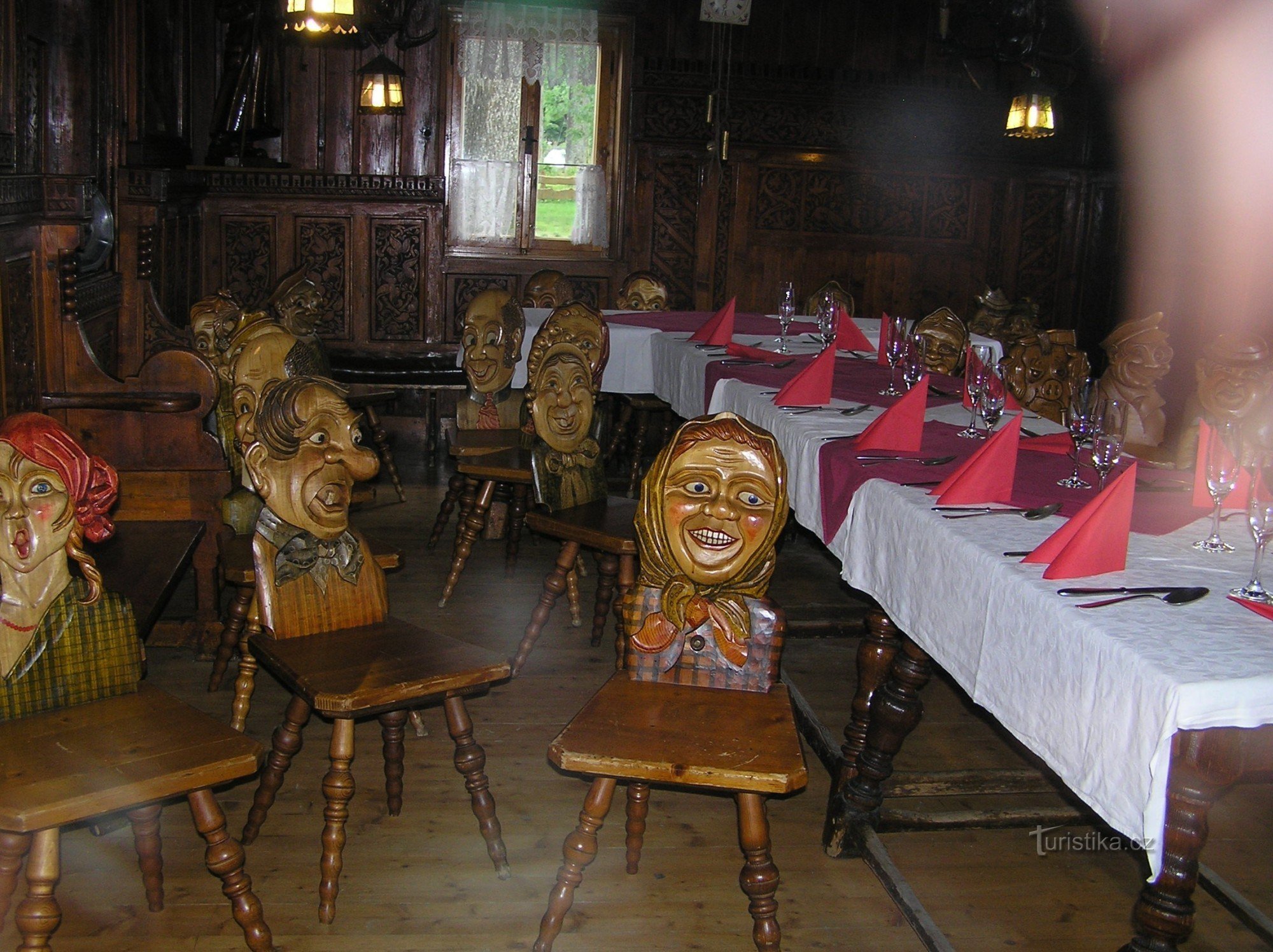 carved chairs in a pub in Rejvíz