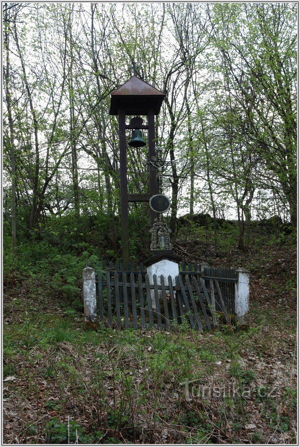 Bell tower with a cross in Sloupno